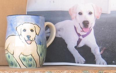 A customer's pet portrait on a mug.
