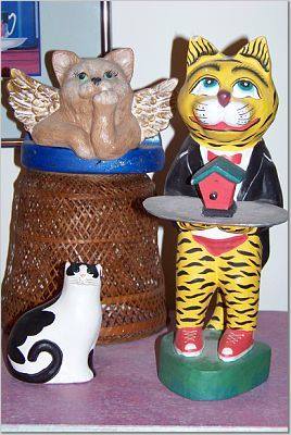 Cat figurines with birdhouse