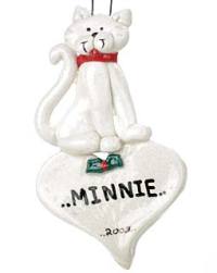 White cat on top of heart ornament